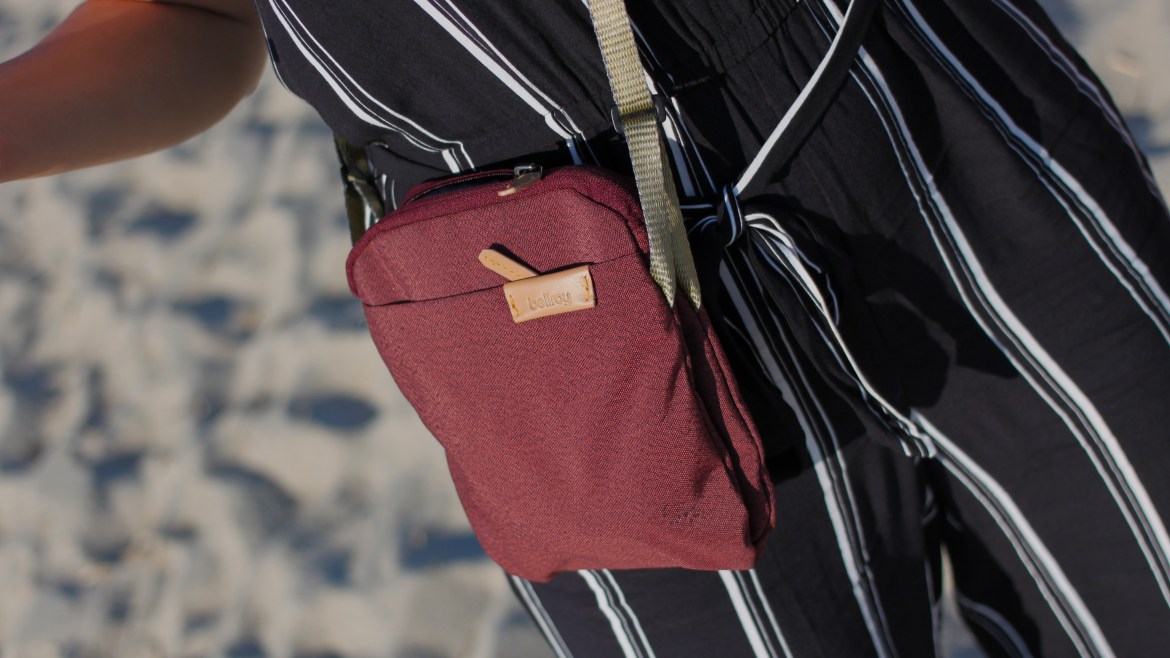 Bellroy City Pouch Review wearing on body leather accent red pouch